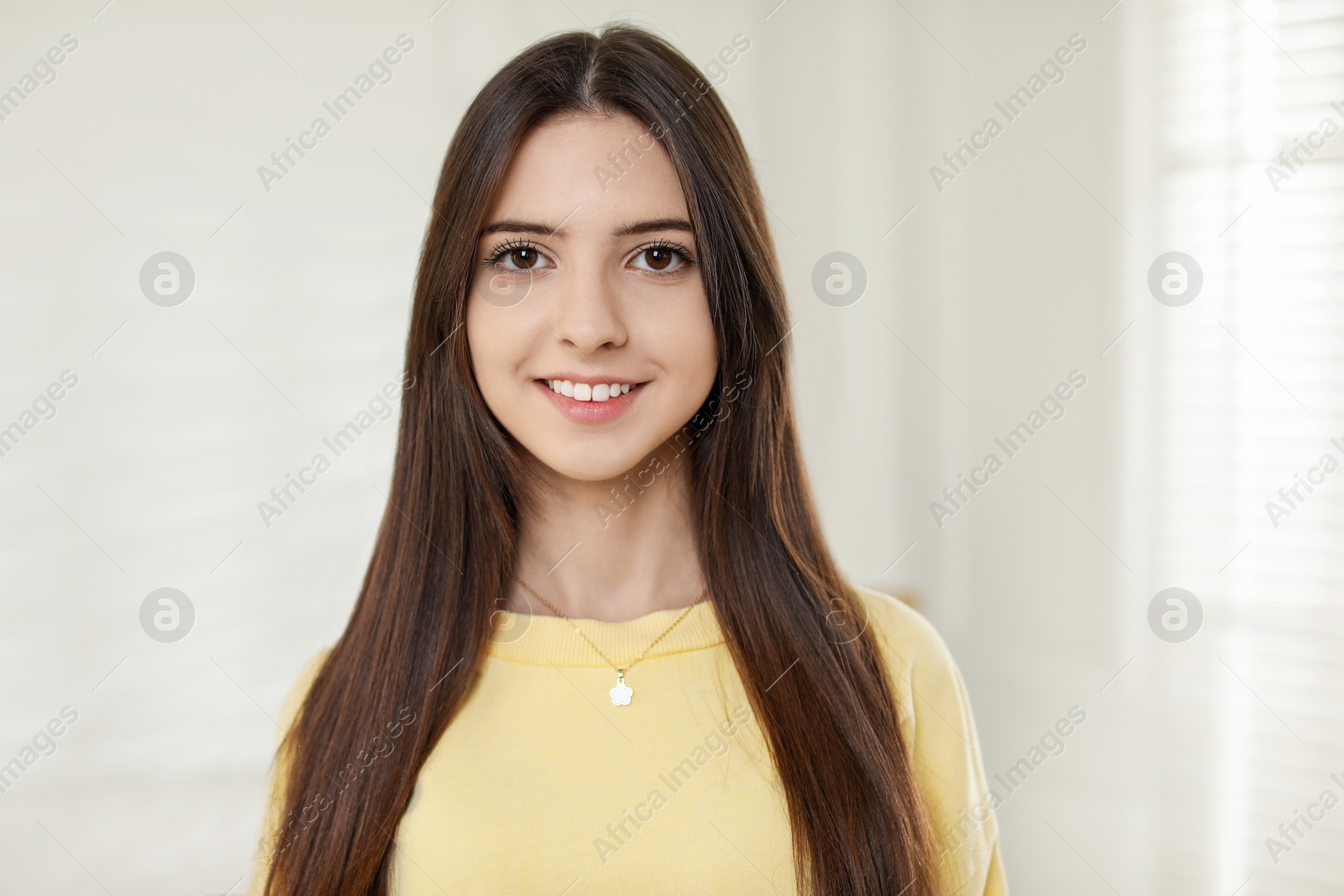 Photo of Portrait of happy teenage girl at home