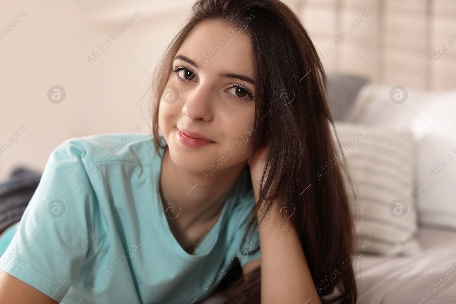 Photo of Portrait of teenage girl on bed at home