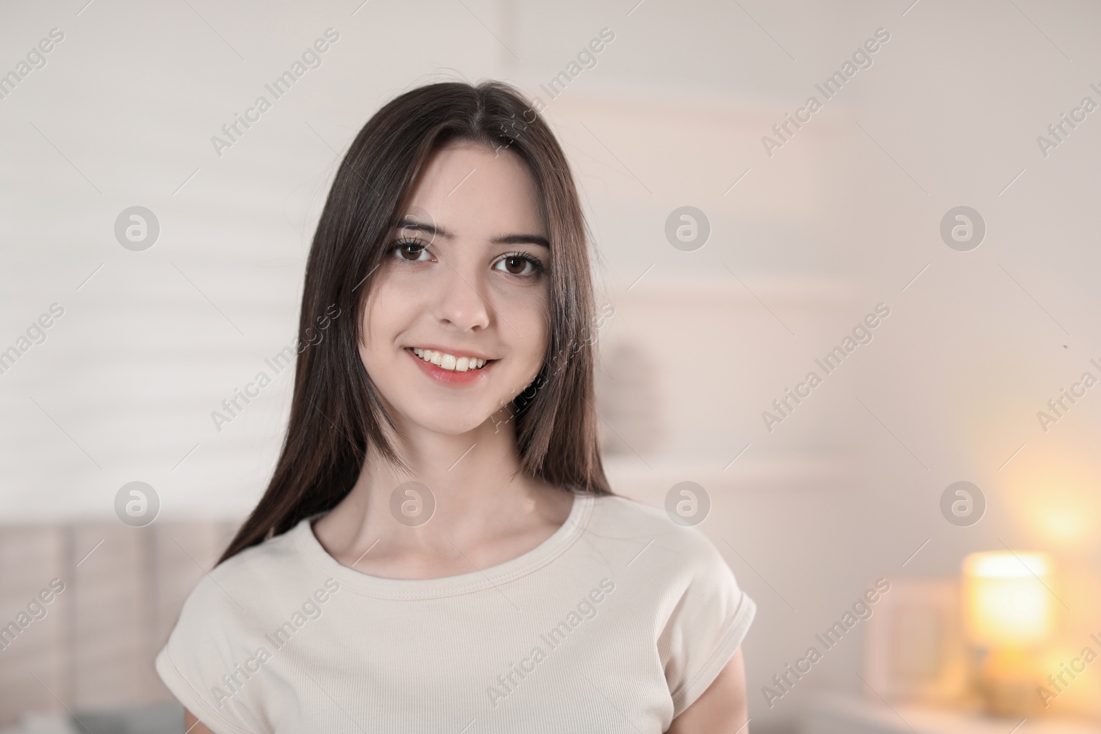 Photo of Portrait of happy teenage girl at home. Space for text