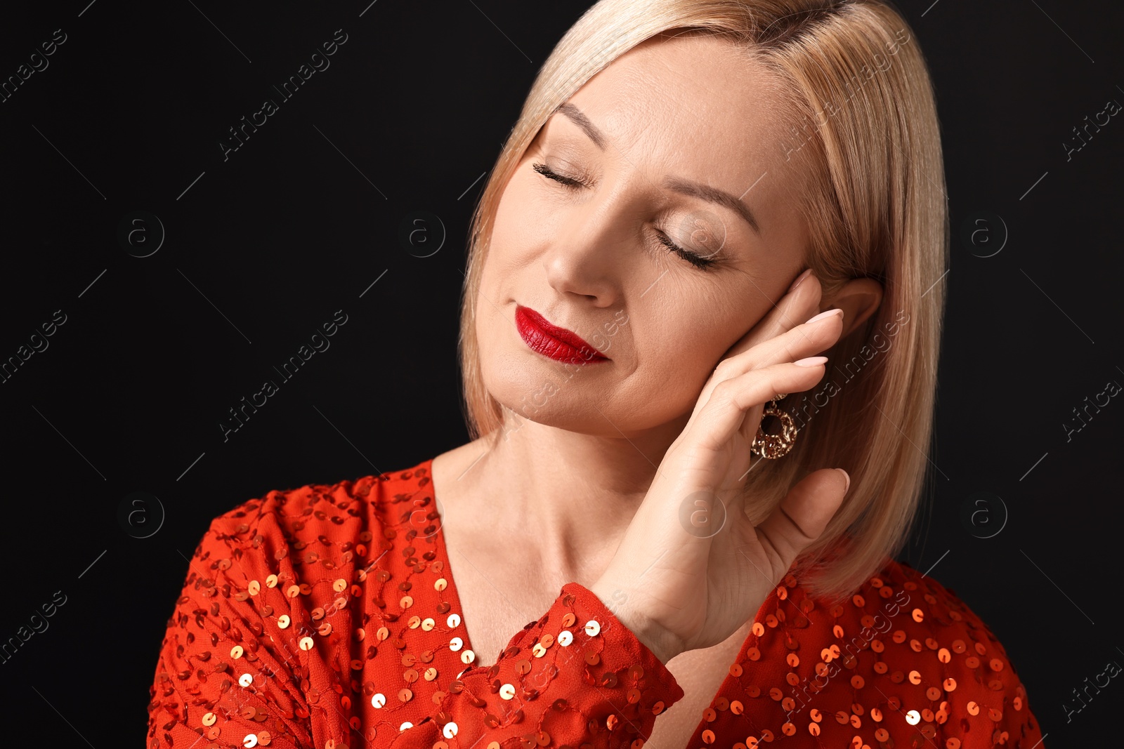 Photo of Woman with perfect makeup on black background