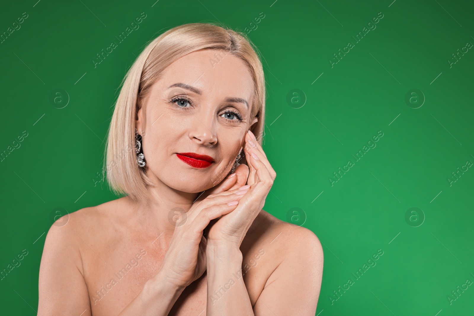 Photo of Woman with perfect makeup on green background. Space for text