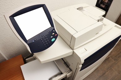 Photo of Modern printer with paper indoors. Printing house