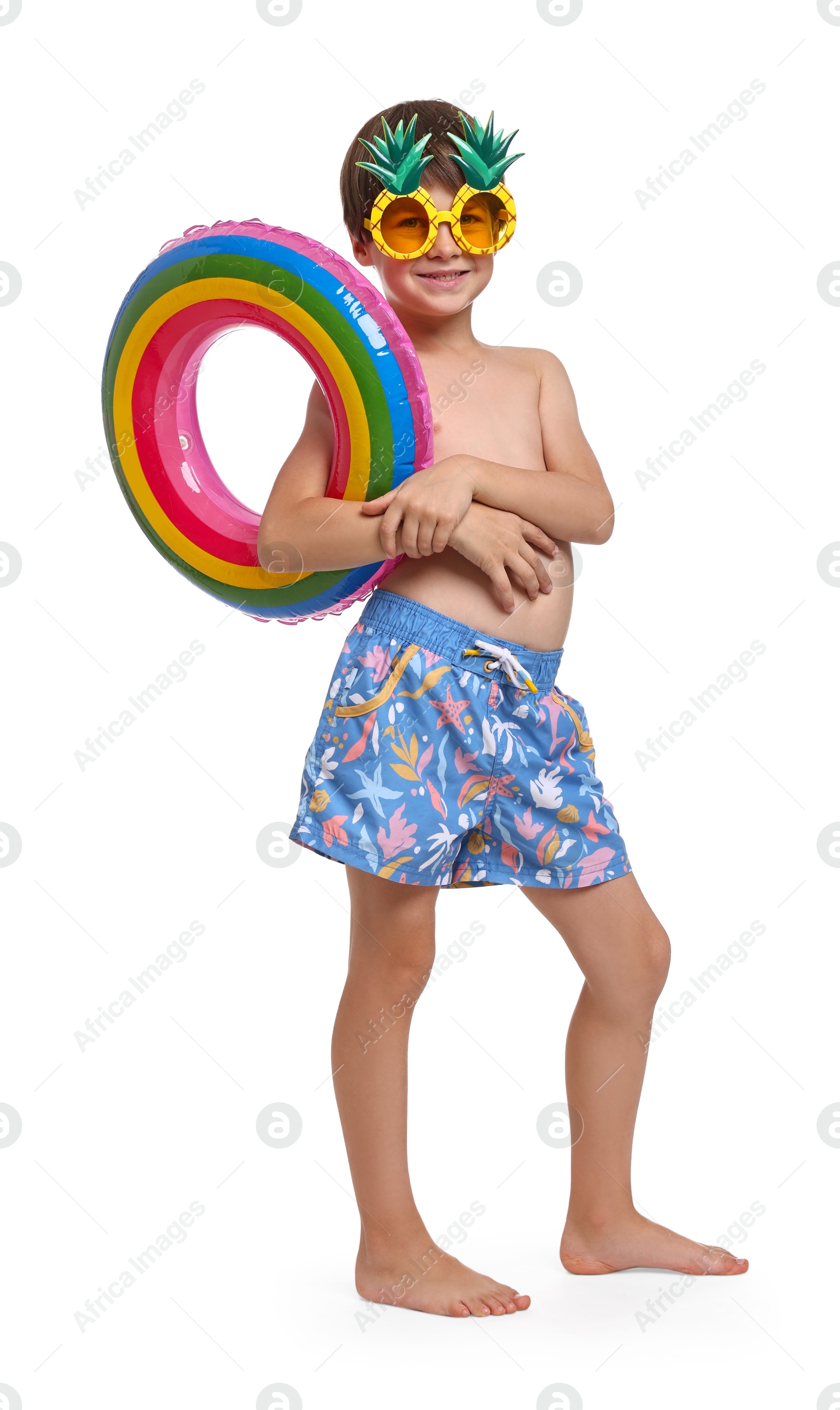 Photo of Little boy in beachwear with inflatable ring on white background