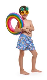 Little boy in beachwear with inflatable ring on white background