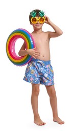 Photo of Little boy in beachwear with inflatable ring on white background