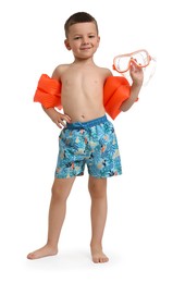 Cute little boy in beachwear with swim armbands and diving mask on white background