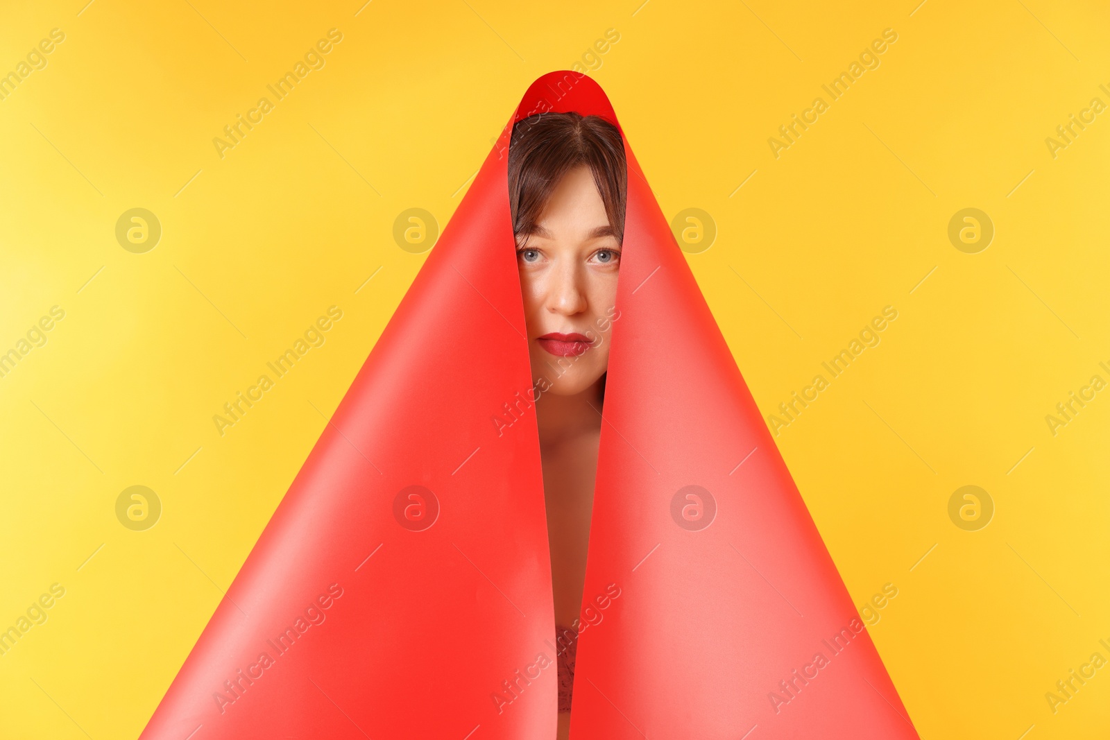 Photo of Beautiful young woman posing on orange background