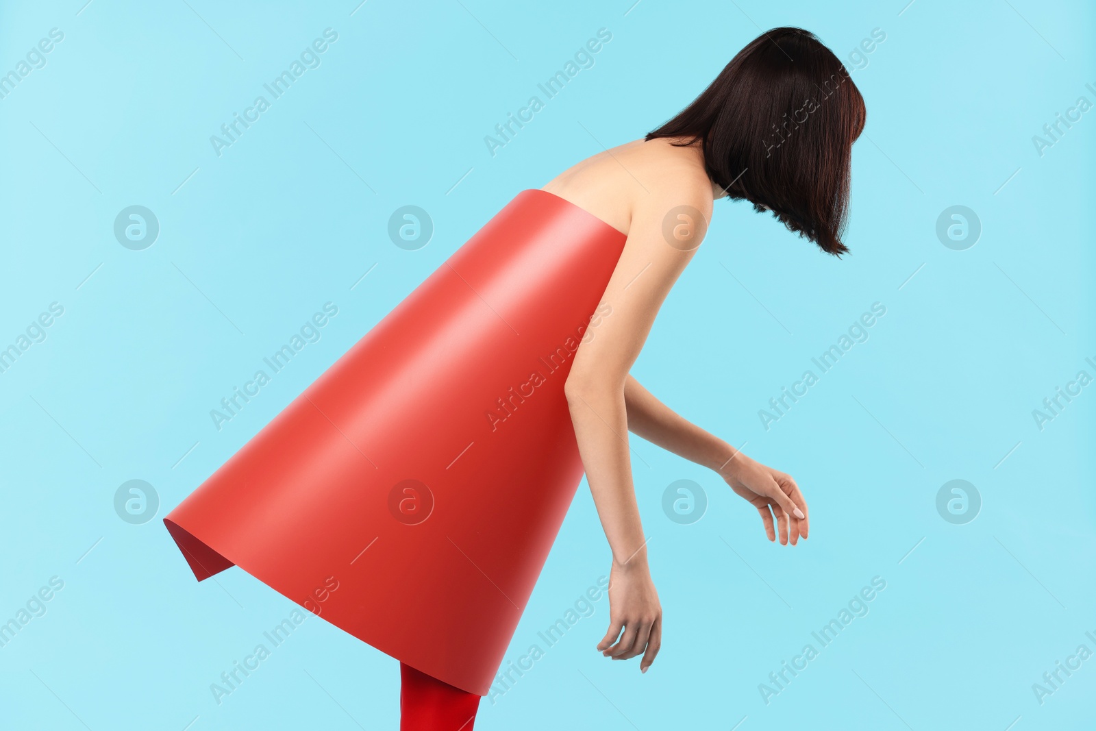 Photo of Young woman posing on light blue background