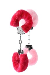 Photo of Bright fluffy handcuffs in air on white background