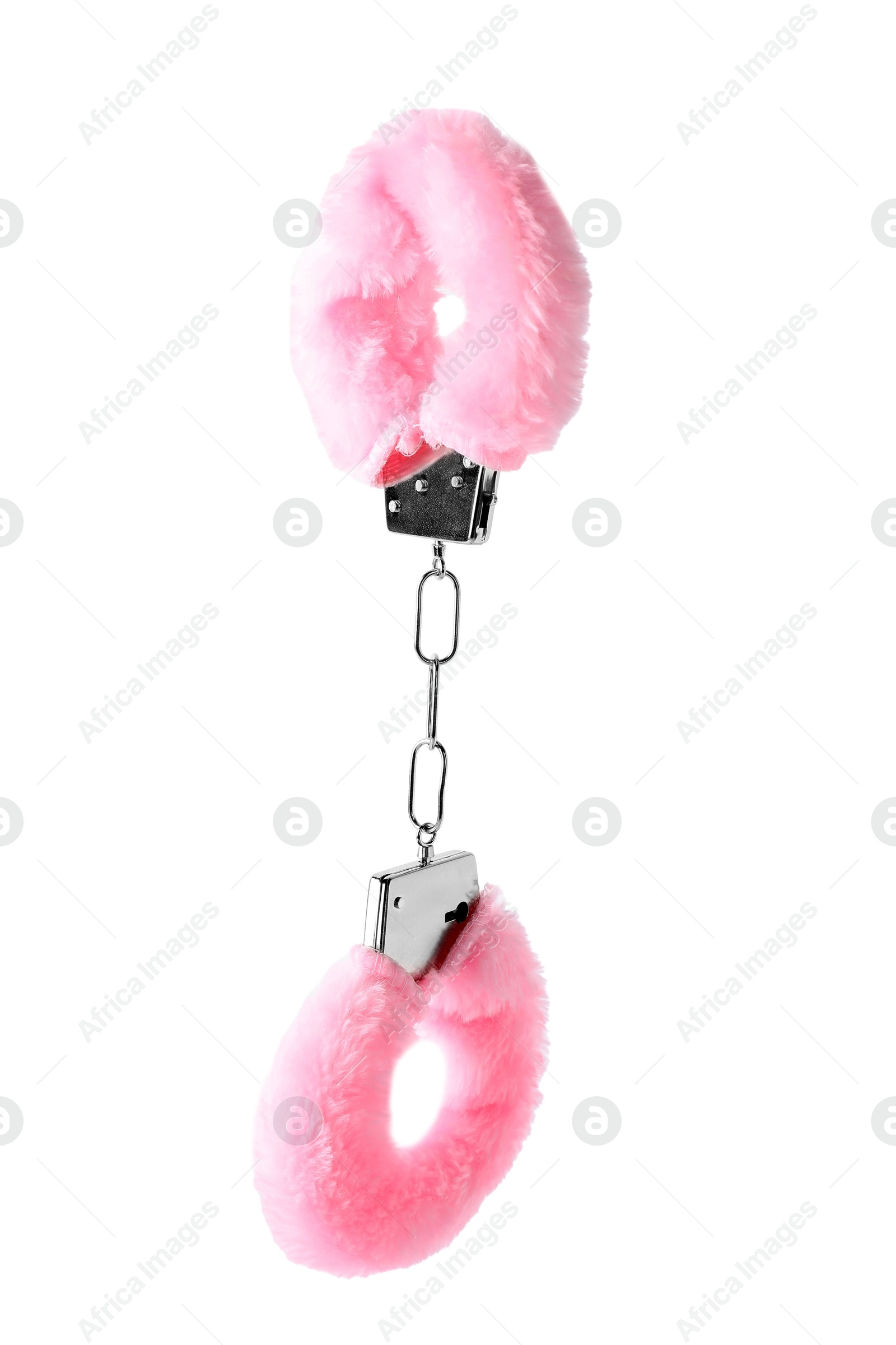 Photo of Pink fluffy handcuffs in air on white background