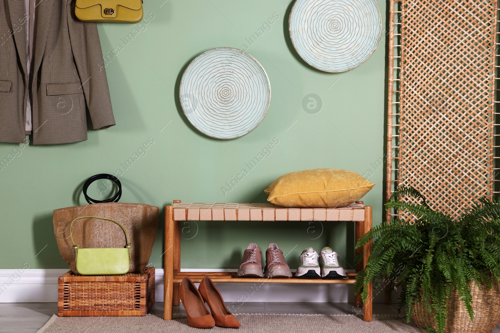 Photo of Stylish hallway interior with bench and folding screen