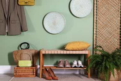 Photo of Stylish hallway interior with bench and folding screen