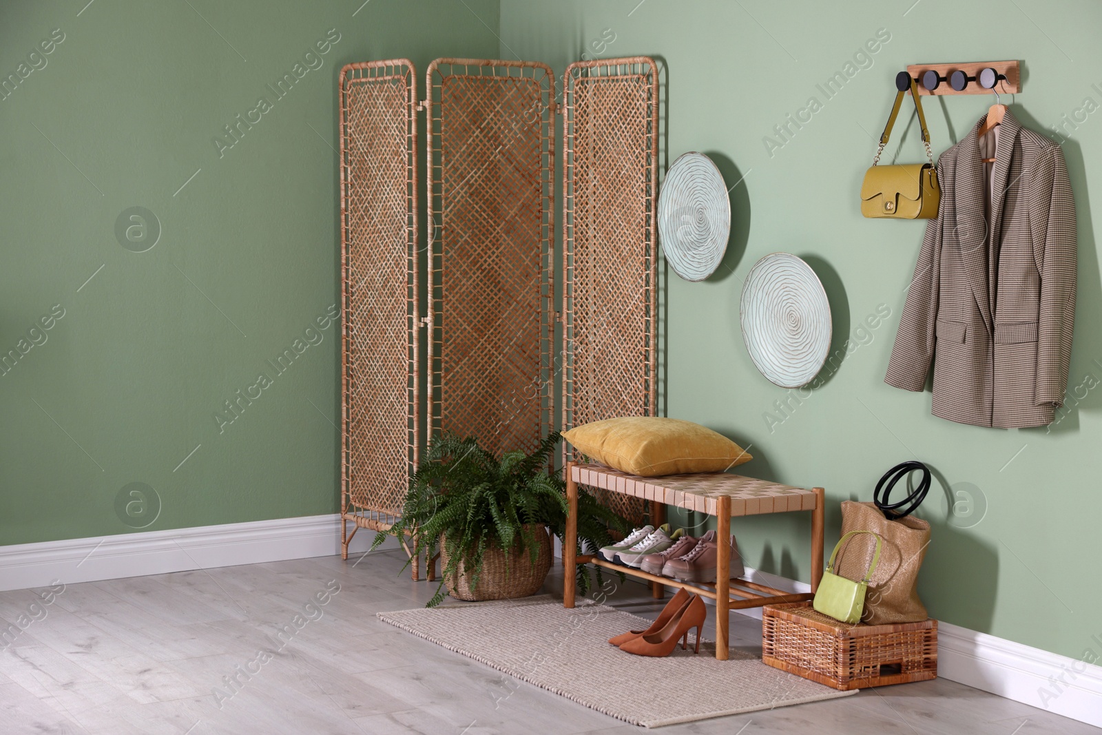 Photo of Stylish hallway interior with bench and folding screen