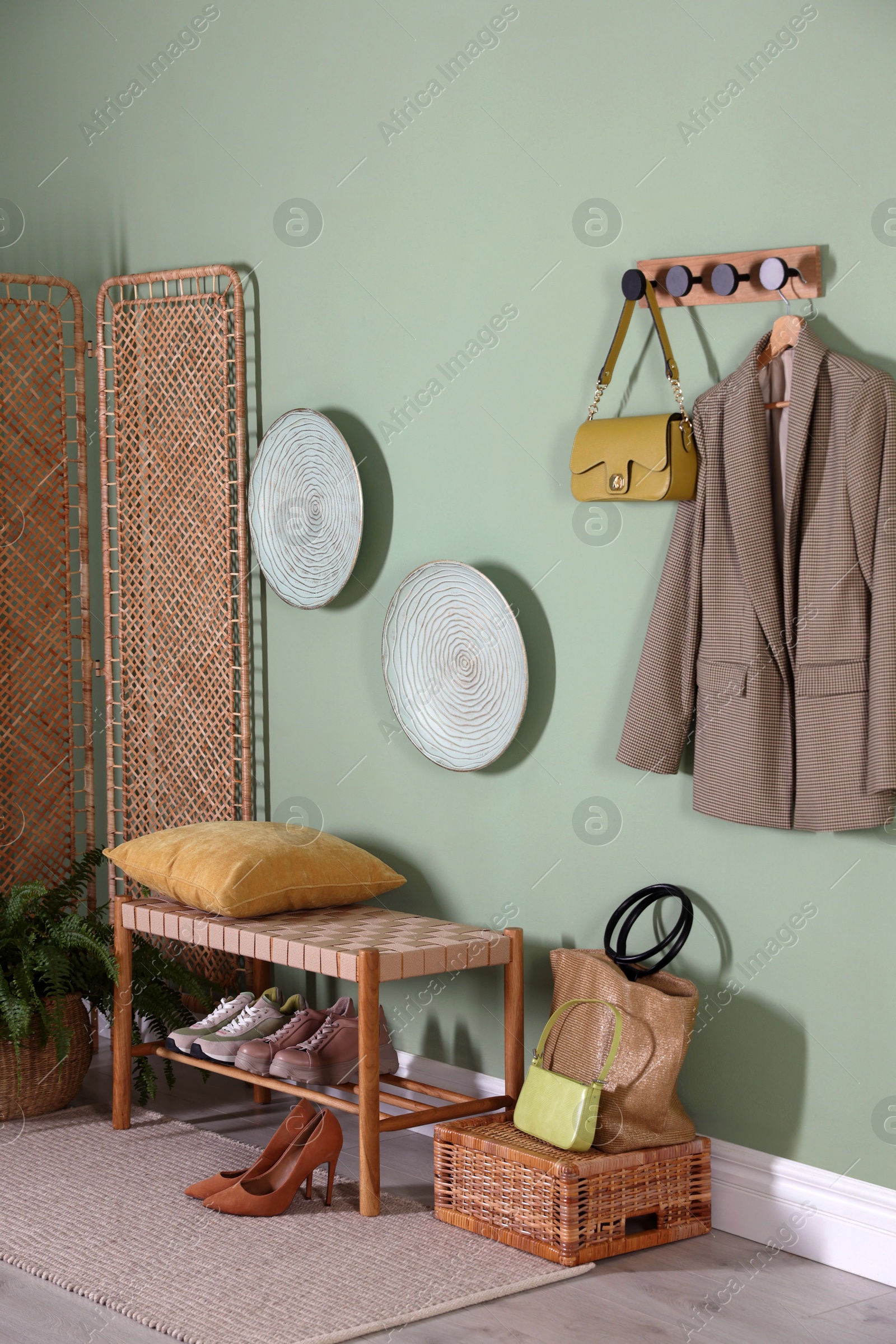 Photo of Stylish hallway interior with bench and folding screen