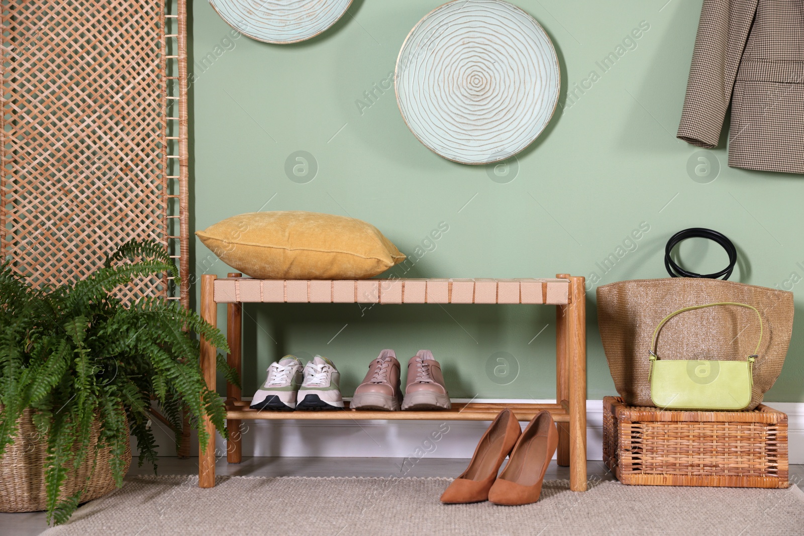 Photo of Stylish hallway interior with bench and folding screen