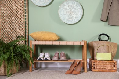 Stylish hallway interior with bench and folding screen