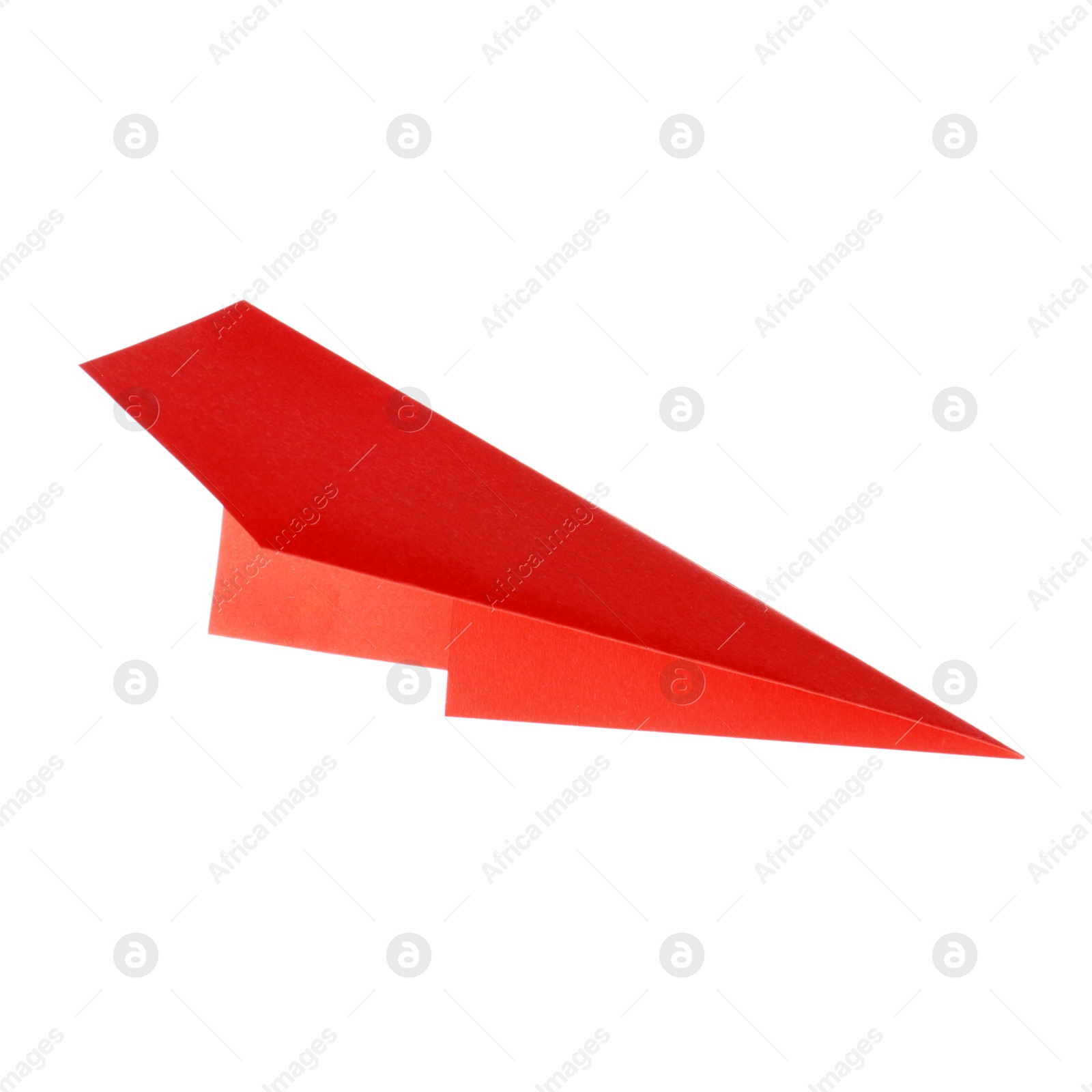 Photo of One handmade coral paper plane isolated on white