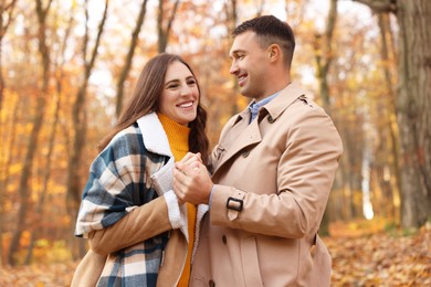 Photo of Happy couple spending time together in autumn park