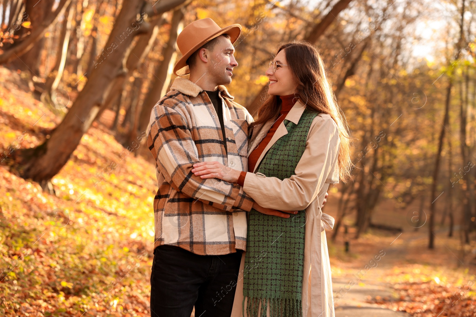 Photo of Happy couple spending time together in autumn park