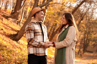 Photo of Happy couple spending time together in autumn park