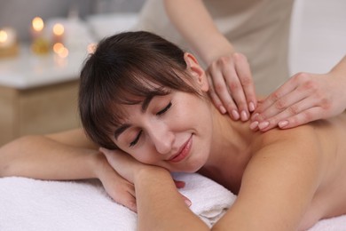 Young woman receiving massage in spa salon