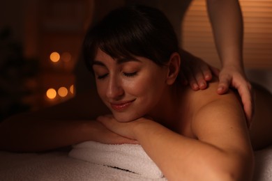 Photo of Young woman receiving massage in spa salon