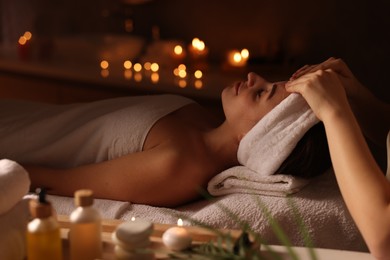 Photo of Young woman receiving massage in spa salon