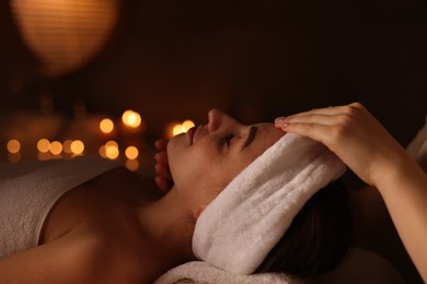 Photo of Young woman receiving massage in spa salon