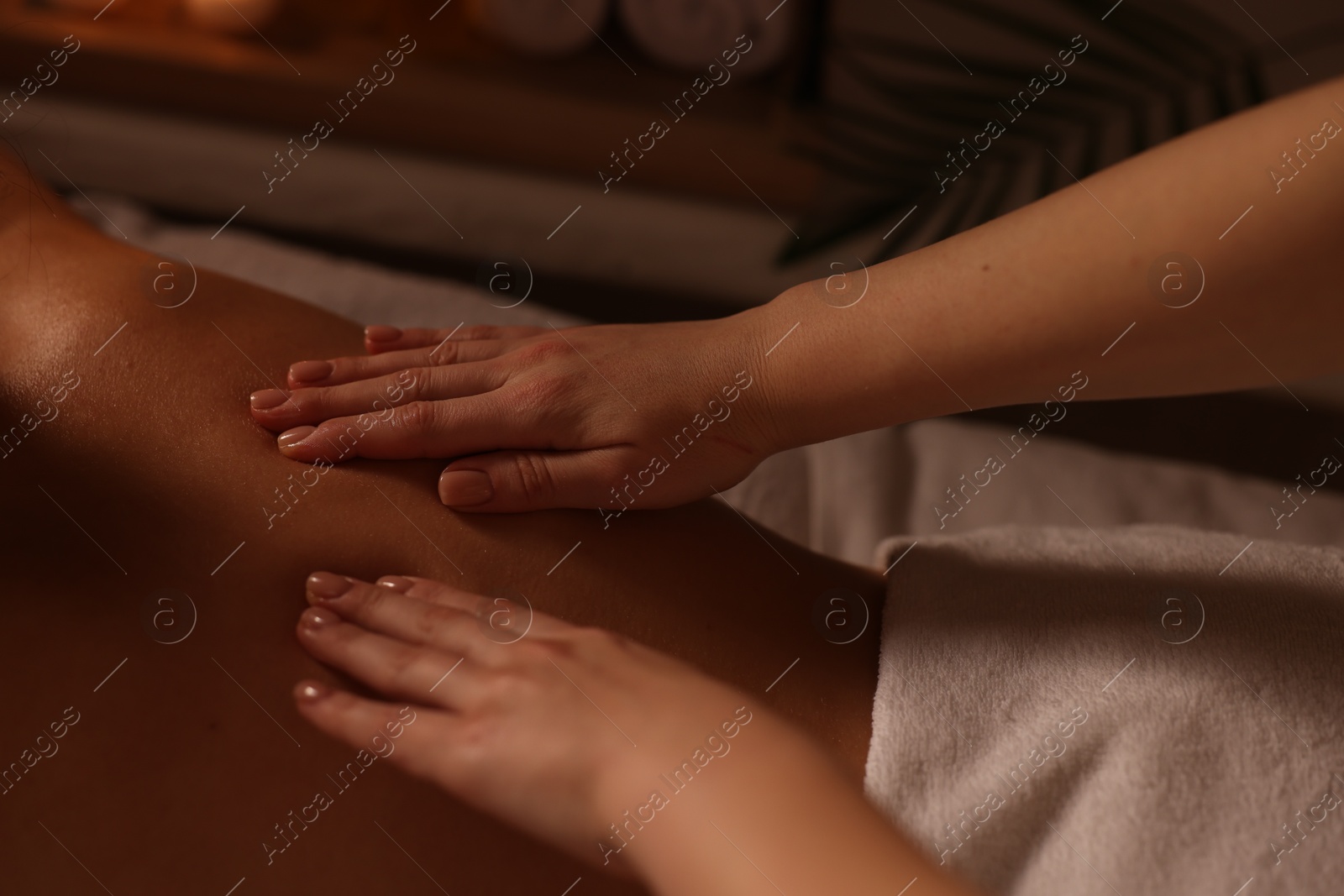 Photo of Woman receiving back massage in spa salon, closeup