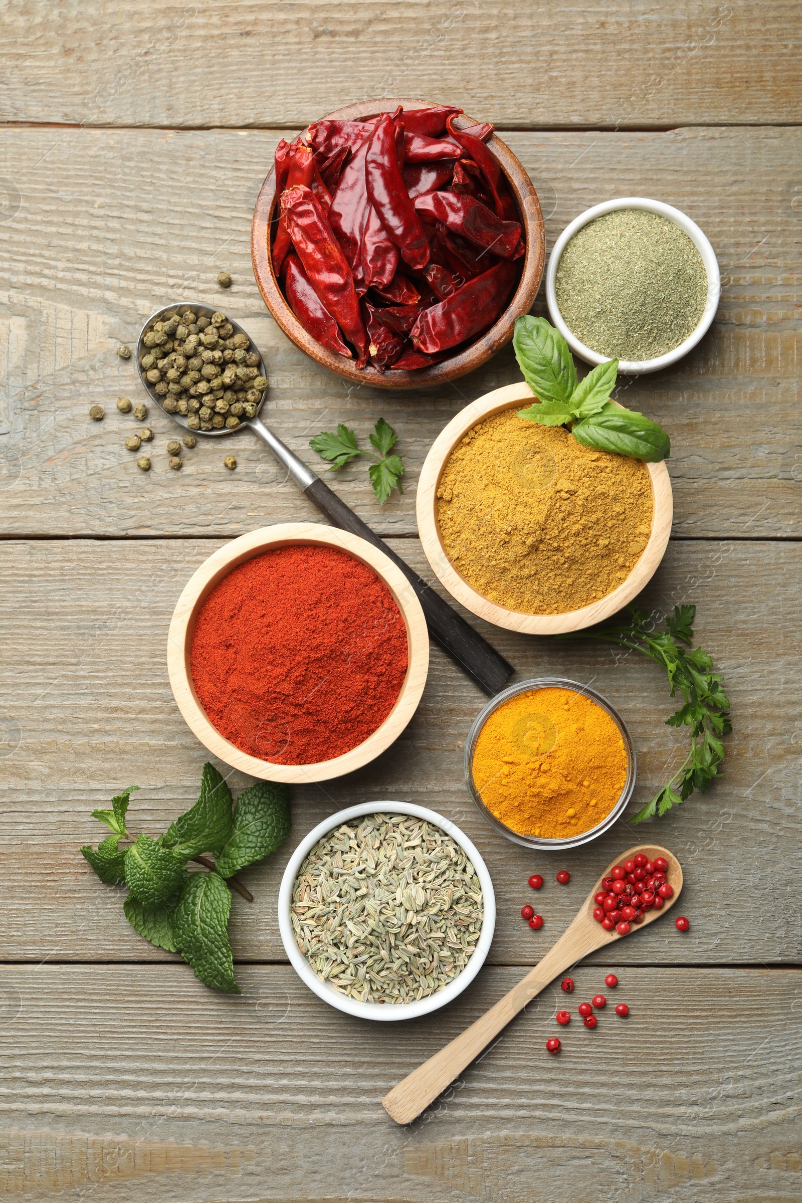 Photo of Different aromatic spices on wooden table, flat lay