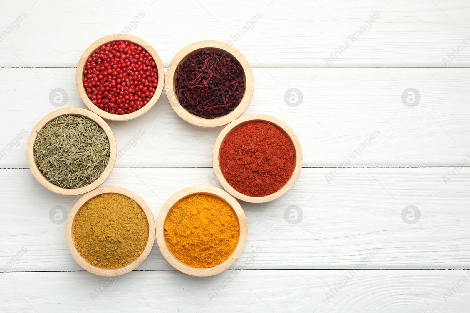 Photo of Different aromatic spices on white wooden table, flat lay