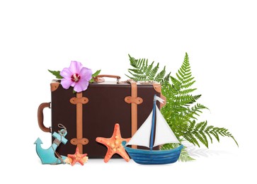 Image of Leather travel suitcase, toy sailboat and anchor, sea stars, tropical leaves and flower on white background