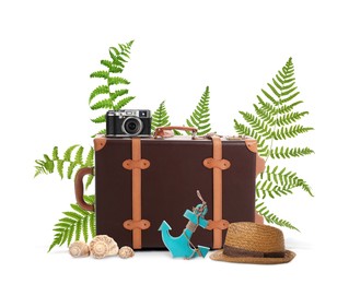 Image of Leather travel suitcase, toy anchor, camera, hat, seashells and tropical leaves on white background