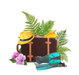 Image of Leather travel suitcase, hat, paper plane, swim fins, tropical leaves and flowers on white background