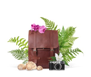 Leather backpack, seashells, camera, tropical leaves and flowers on white background. Time to travel