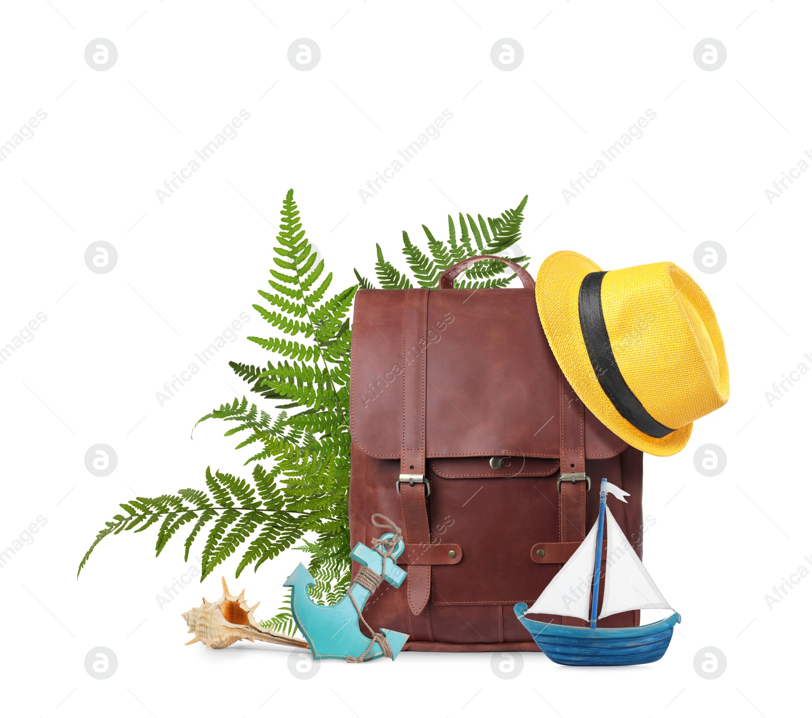 Image of Leather backpack, tropical leaves, hat, seashell, toy sailboat and anchor on white background. Time to travel