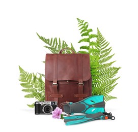 Image of Leather backpack, camera, swim fins, tropical leaves and flower on white background. Time to travel