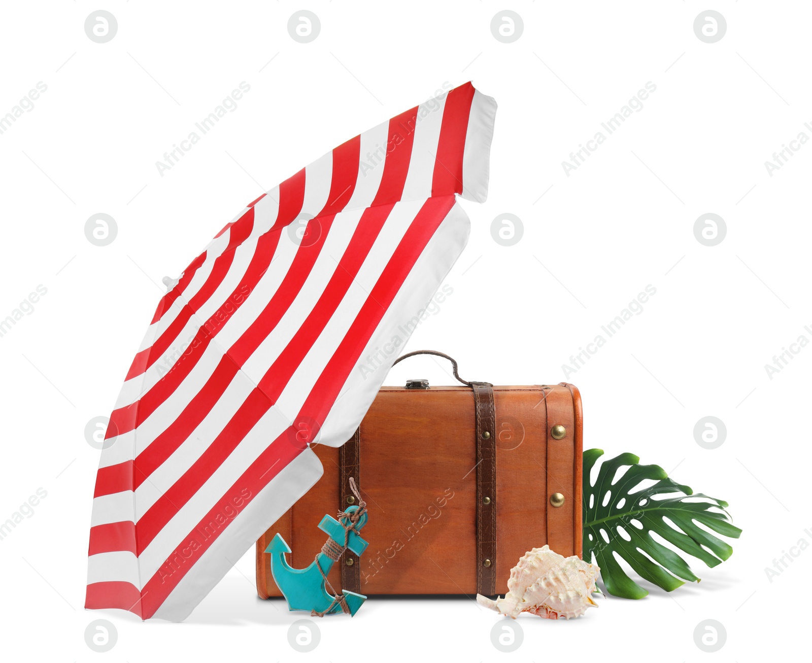 Image of Brown travel suitcase, tropical leaf, seashell, beach umbrella and toy anchor on white background