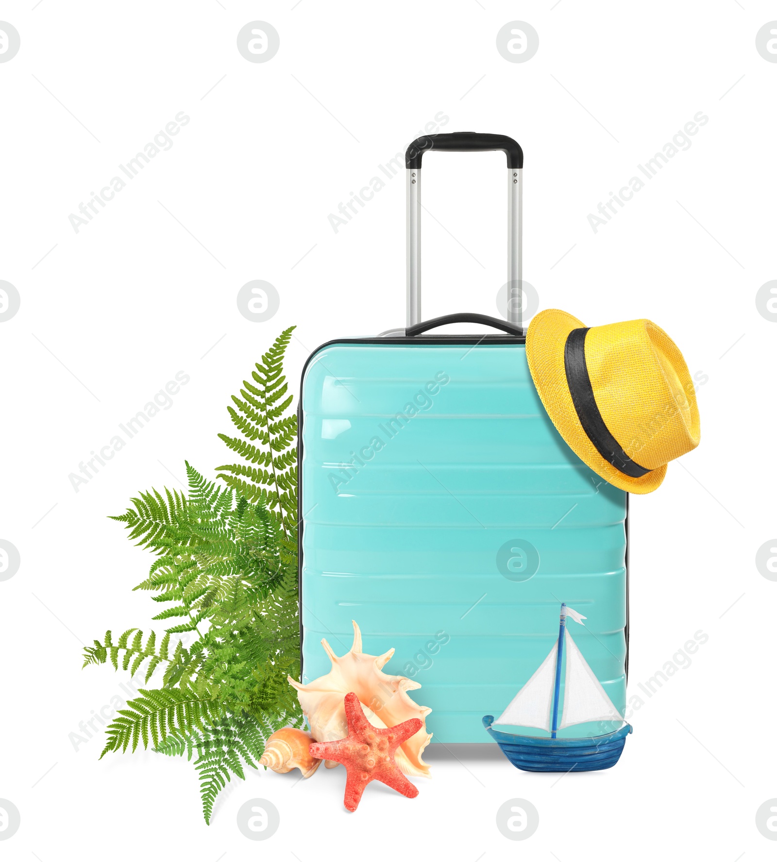 Image of Turquoise travel suitcase, tropical leaves, hat, sea star, seashells and toy sailboat on white background