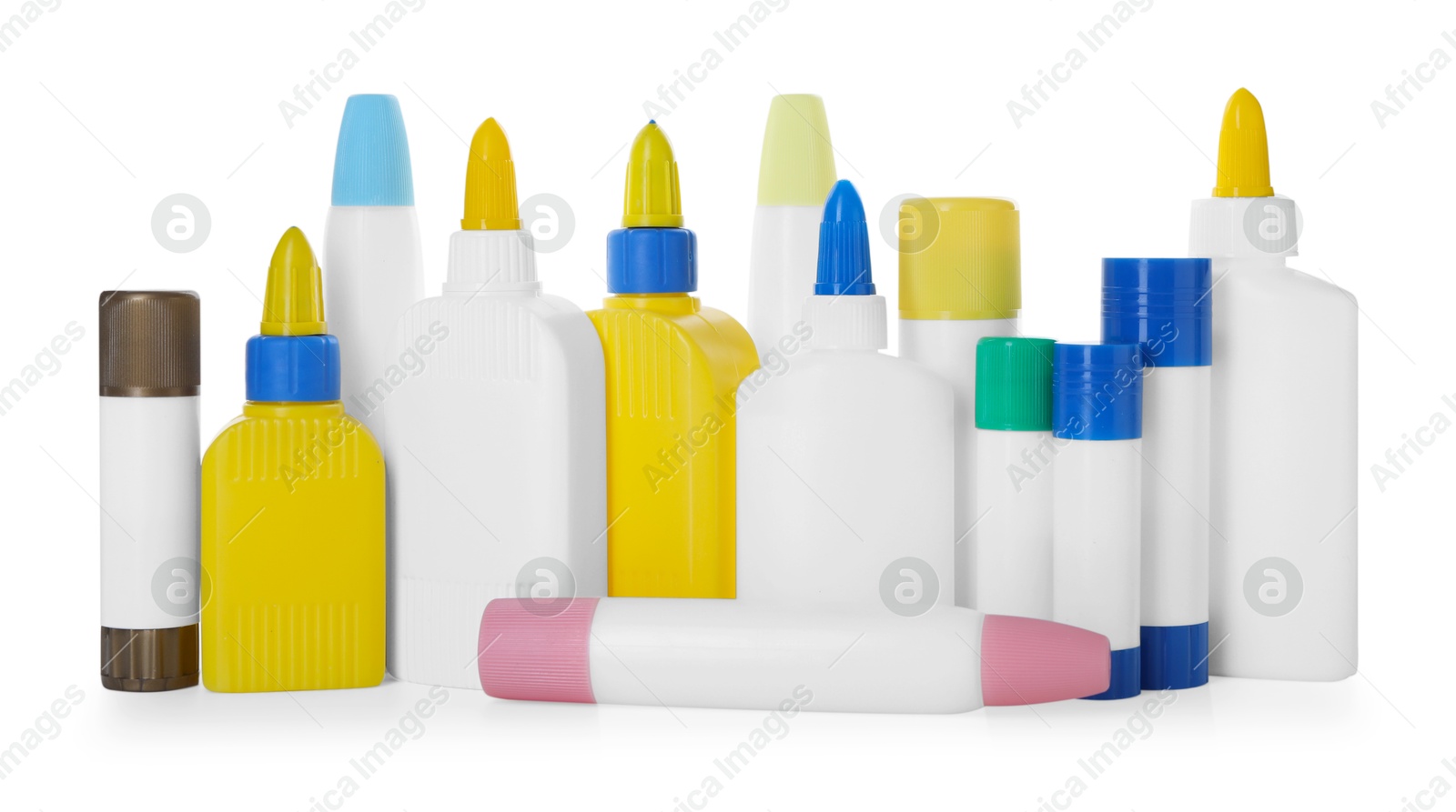 Photo of Bottles and sticks of glue on white background