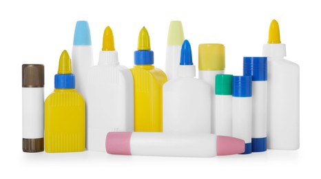 Photo of Bottles and sticks of glue on white background