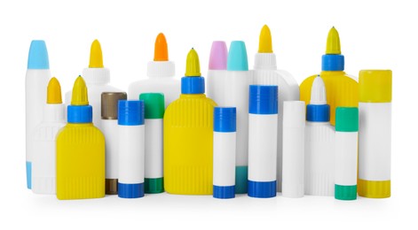 Photo of Bottles and sticks of glue on white background