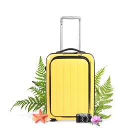 Yellow travel suitcase, camera, sea star, seashell, tropical leaves and flower on white background