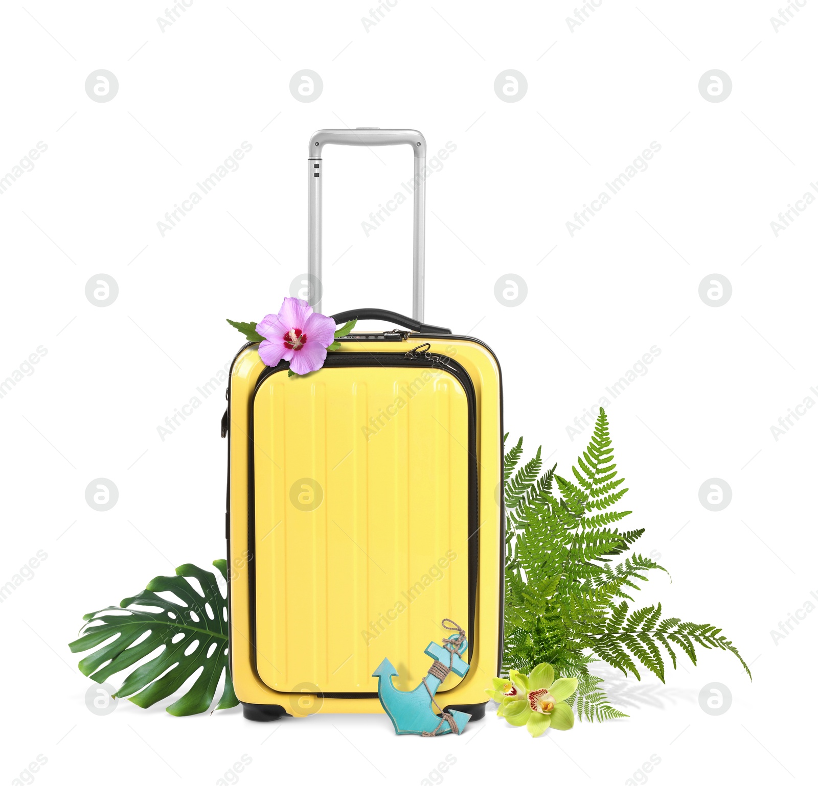 Image of Yellow travel suitcase, toy anchor, tropical leaves and flowers on white background