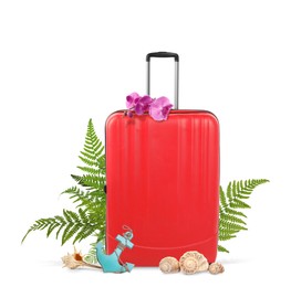 Red travel suitcase, seashells, toy anchor, tropical leaves and flowers on white background