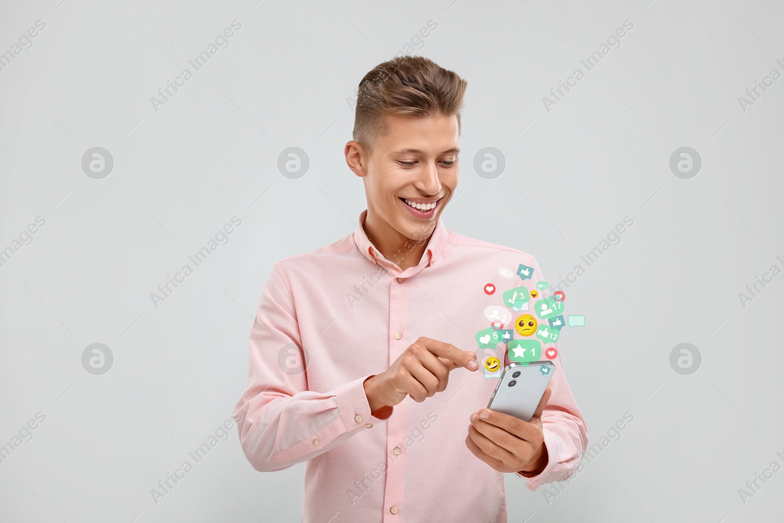 Image of Happy man using mobile phone on white background. New message sign and other notifications over gadget