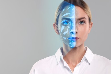 Facial recognition system. Woman undergoing biometric verification on grey background