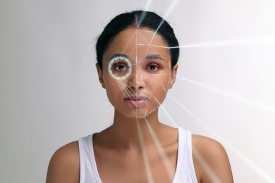 Facial and iris recognition system. Woman undergoing biometric verification on white background