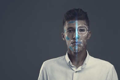 Image of Facial and iris recognition system. Man undergoing biometric verification on grey background