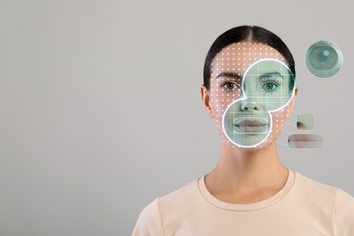 Image of Facial and iris recognition system. Woman undergoing biometric verification on grey background